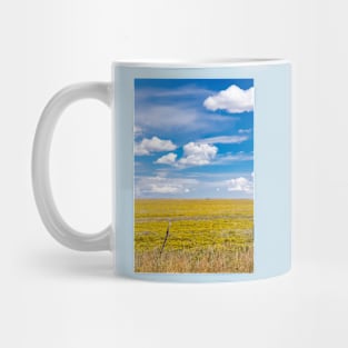 Yellow fields under blue cloudy sky Mug